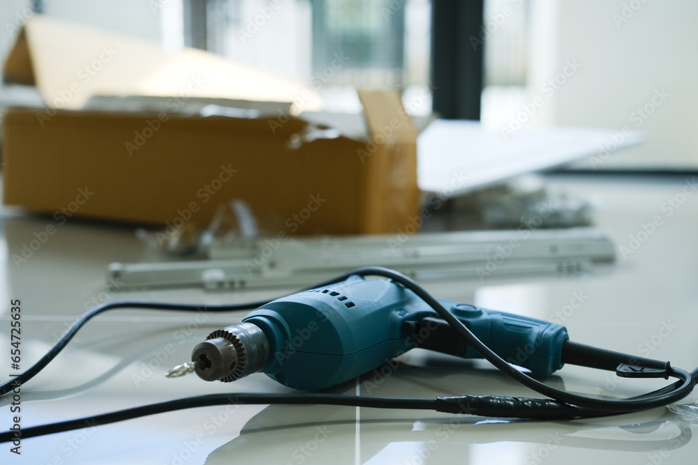 Electric screwdriver and another equipment on floor. Repairing home interior, assembly and improvement concepts Electric screwdriver and another equipment on floor. Repairing home interior, assembly and improvement concepts