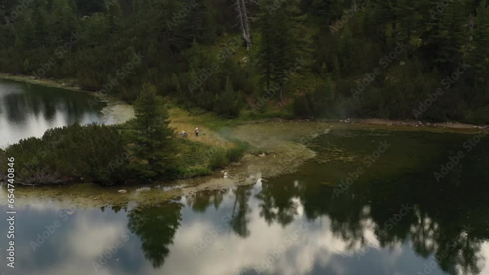 Flight over tourists on Vasilashko lake in Pirin mountain in Bulgaria, Europe. HQ 4K Apple ProRes video. Flight over tourists on Vasilashko lake in Pirin mountain in Bulgaria, Europe. HQ 4K Apple ProRes video.