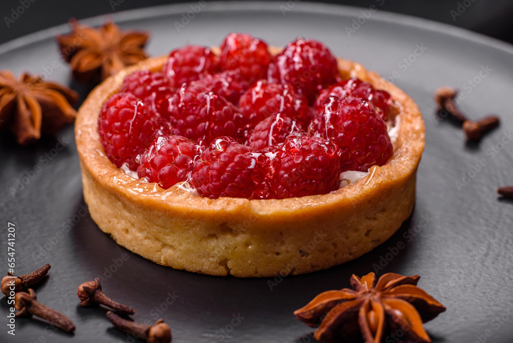 Delicious fresh sweet round tart with ripe raspberries and cream Delicious fresh sweet round tart with ripe raspberries and cream