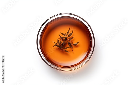 Black tea in a glass cup top view isolated on white