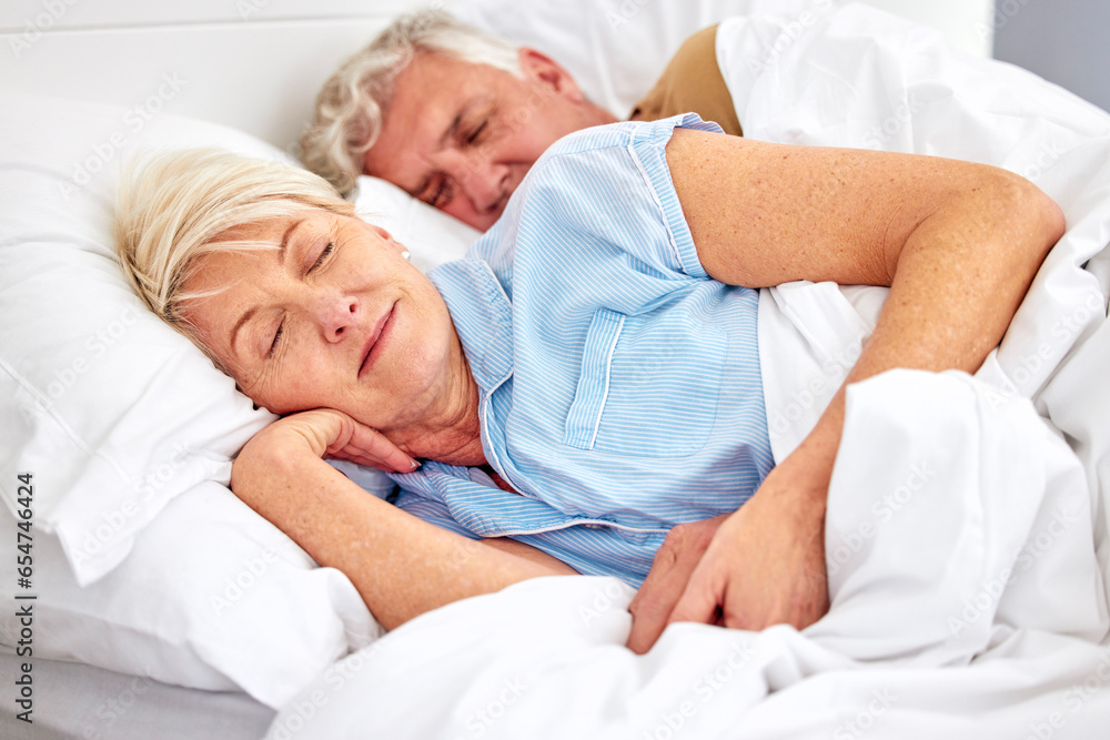 Fototapeta premium Sleeping, bedroom and senior couple with love, relax and retirement on a weekend break, resting and calm. Peace, old woman or elderly man in a bed, home or morning with care, marriage or relationship