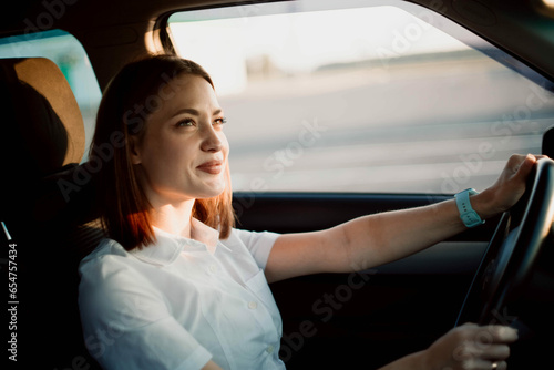 beautiful successful woman drives a car to work. The life of a modern woman driver.