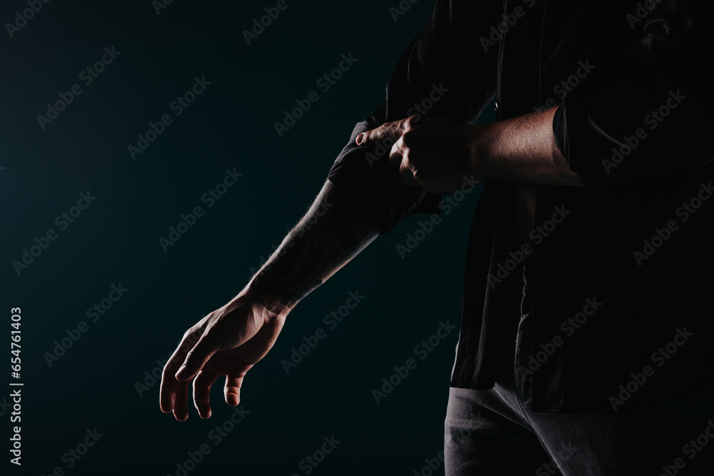 Confident Fit Man Showing Strong Muscles in Studio Silhouette Confident Fit Man Showing Strong Muscles in Studio Silhouette