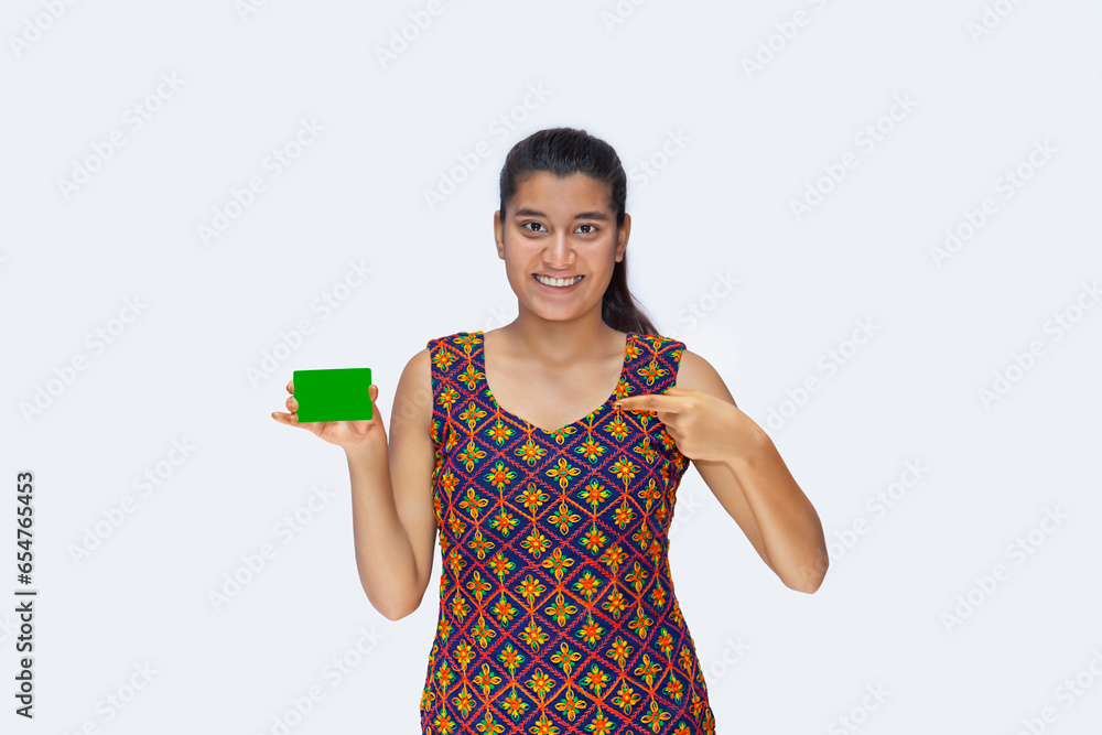 Extremely Happy, Satisfied Girl pointing at Green Screen on Credit Card, against white background Extremely Happy, Satisfied Girl pointing at Green Screen on Credit Card, against white background