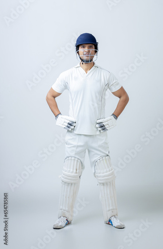 Full body portrait of Man in cricketer dress on isolated background looking towards the camera, cricket concept
