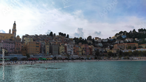 Menton, France, October 6, 2021: Sablettes beach in Menton is located between the two ports (the Old Port and Garavan), along the Quai Bonaparte and the old town.