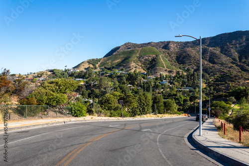Residential Area near the Hollywood Reservoir. Hollywood Hills looking down on some beautiful houses on the opposite hillside in Los Angeles, California in the summer.