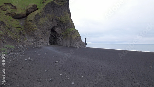 The Reynisfjara Black sand beach, Halsanefshellir cave, basalt columns and sea stacks at Vik i Myrdal in Iceland. photo