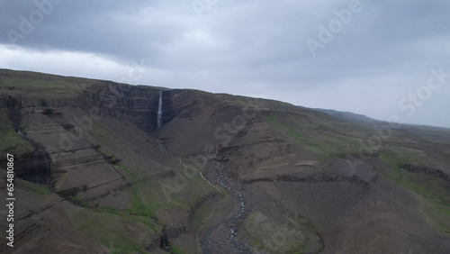 AERIAL VIEW Hengifoss is a waterfall that runs from the river Hengifossá in the municipality of Fljótsdalshreppur in East Iceland. At 128 meters (420 feet) it is the third tallest waterfall in Iceland photo