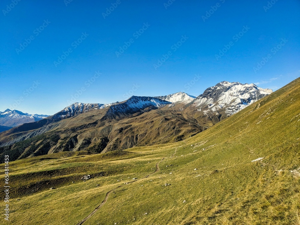 Autumn mountain panorama in the Parsenn Davos Klostes Mountains. Hiking and trail running or biking in the Alps. Snowy mountain peaks.  Wanderlust. High quality photo