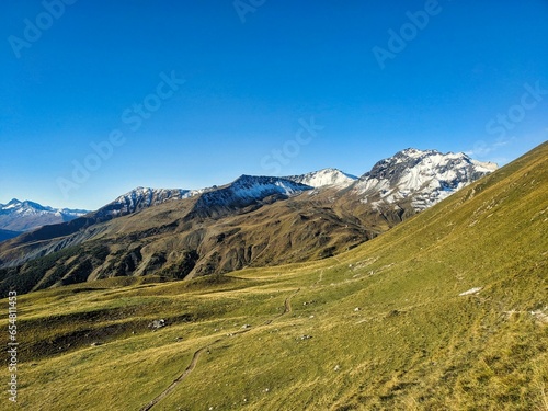 Autumn mountain panorama in the Parsenn Davos Klostes Mountains. Hiking and trail running or biking in the Alps. Snowy mountain peaks. Wanderlust. High quality photo