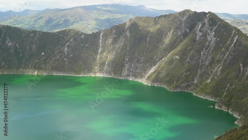 Laguna Quilotoa is a water filled crater lake and the most western volcano in the Ecuadorian Andes. Caldera with turquoise body of water and a popular hiking trail called quilotoa loop.