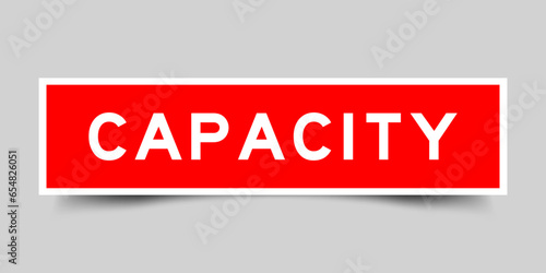 Red color square label sticker with word capacity on gray background