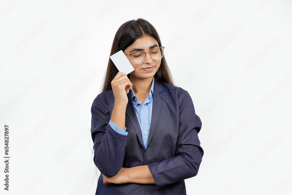 Beautiful young blonde woman holding up a credit card while avoiding her eyes from the copy space in the picture pose. Beautiful young blonde woman holding up a credit card while avoiding her eyes from the copy space in the picture pose.