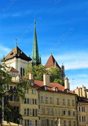 View of the spire of the Geneva Saint Pierre Cathedral against the background of old houses.