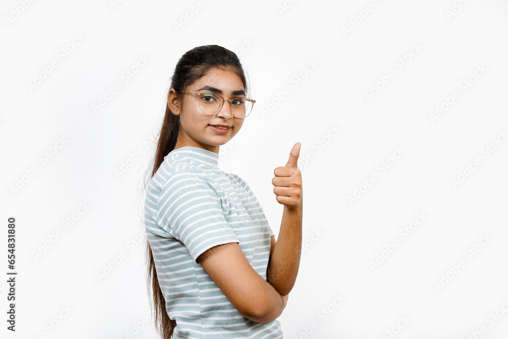 Standing over a white background, a picture of a confident Asian woman giving the thumbs-up and saying something is good. Standing over a white background, a picture of a confident Asian woman giving the thumbs-up and saying something is good.