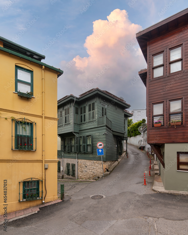 Facade of colorful wooden residential buildings painted in green, yellow and brown at an alley suited in Kuzguncuk neighborhood, Uskudar district, Istanbul, Turkey