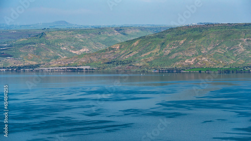 Tableau sur toile View across the Sea of Galilee of the Golan Heights and the lake with reflection