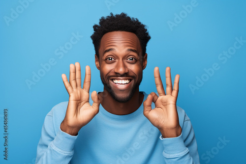 A picture of a happy young black man making an okay sign with his hands, black firday photo photo
