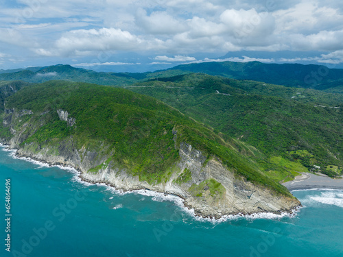 Drone fly over the sea and shore with mountain photo