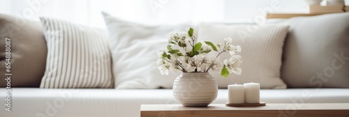 home interior design element close up freshness flower vase on coffee table in living room with background of white colour sofa and pillow daylight cosy comfort home interior background photo