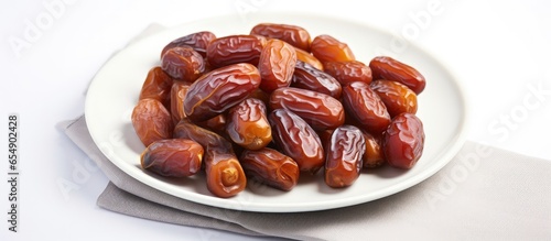 Top view of organic dried dates fruits on a white plate with copy space with copyspace for text