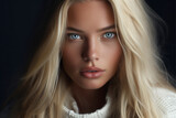 Close-up portrait of a very beautiful young woman with light blue / gray eyes and long blonde hair, wearing a white sweater top - isolated, dark background