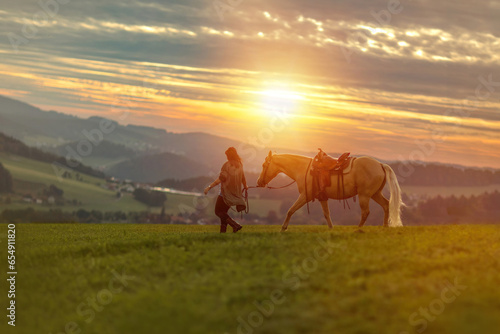 Horse and equestrian team: A young woman and her palomino caballo deporte espanol horse during sundown in summer outdoors © Annabell Gsödl