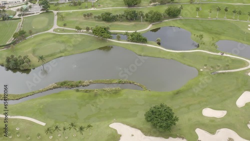 Aerial view of Miami Beach Golf Club course in South Beach with golfers and surounding landscape - 4K Drone photo