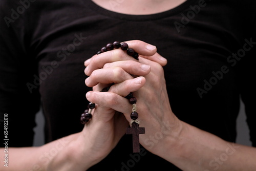 praying to God with hands together on grey black background with people stock image stock photo