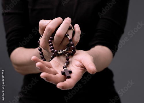 praying to God with hands together on grey black background with people stock image stock photo