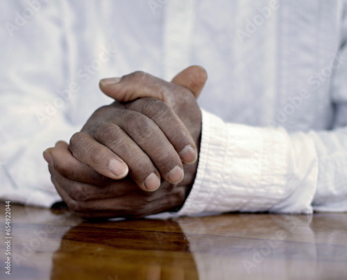 praying to God with hands together on grey black background with people stock image stock photo photo