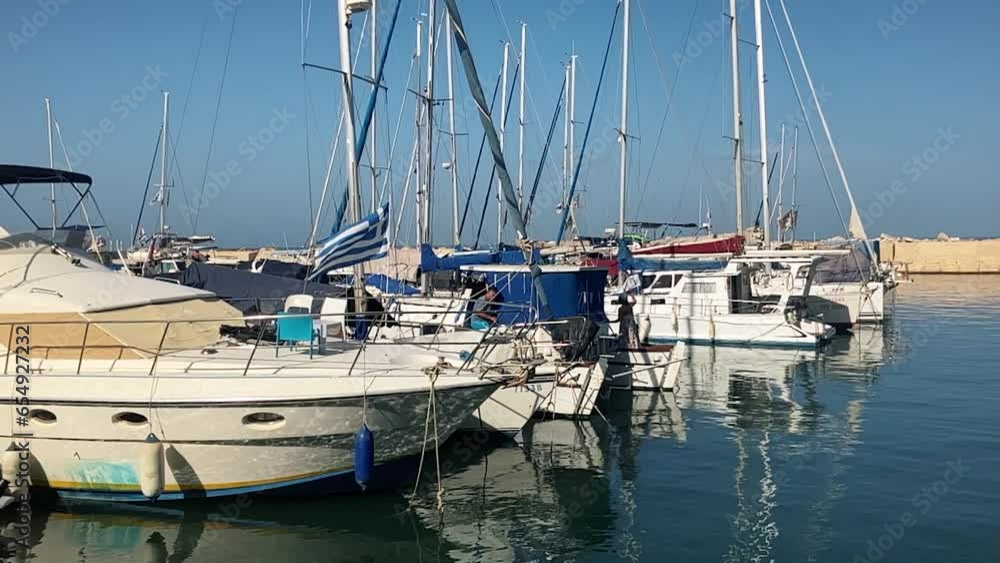Marina, yacht parking. Sailing boat with the flag of Greece. Marina, yacht parking. Sailing boat with the flag of Greece.
