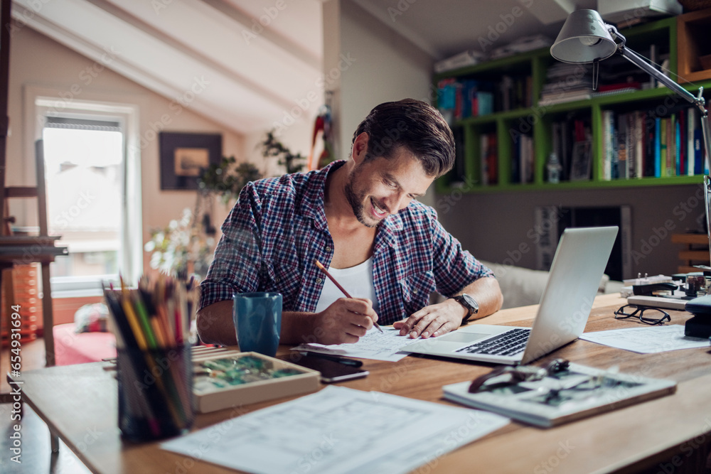 Young male architect working on design from home Young male architect working on design from home