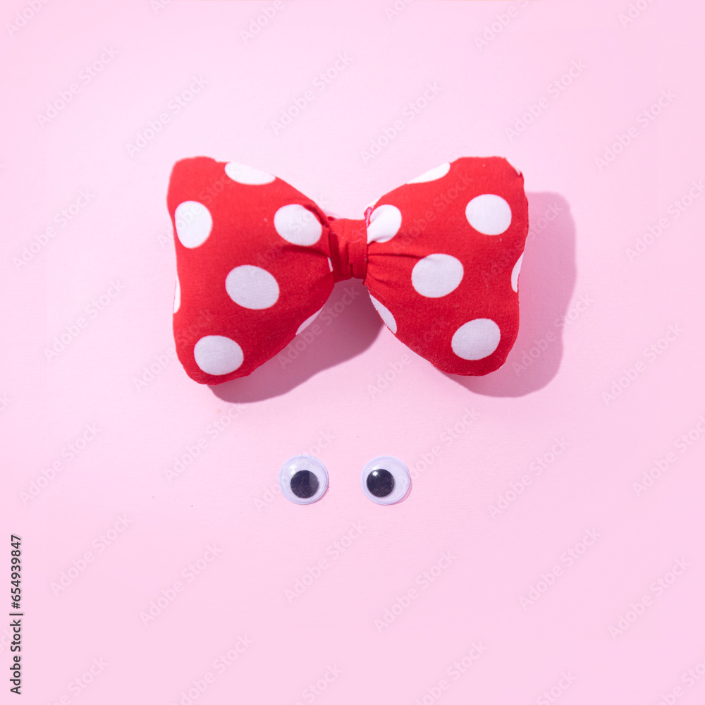 Minimal girl's face with with dotted bow on head. Creative aesthetic summer fashion trend layout. Minimal girl's face with with dotted bow on head. Creative aesthetic summer fashion trend layout.