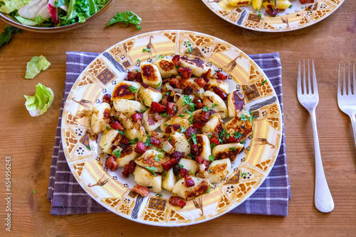 A traditional Polish cuisine dish: potato dumplings with bacon and onion