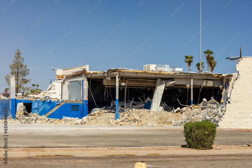 Rubble and scrap metal of destroyed buildings palm trees in background Rubble and scrap metal of destroyed buildings palm trees in background