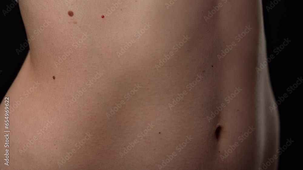 Closeup shot of beautiful caucasian woman body part, tummy and ribs area smooth skin, breathing deeply. Closeup shot of beautiful caucasian woman body part, tummy and ribs area smooth skin, breathing deeply.