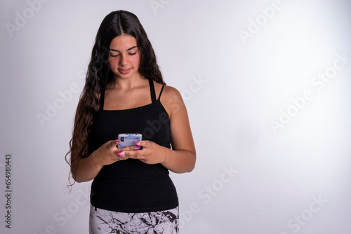 "Young Caucasian Woman Thoughtfully Sending a Heartfelt and Encouraging Message on Her Mobile Phone, Spreading Positivity and Warmth."