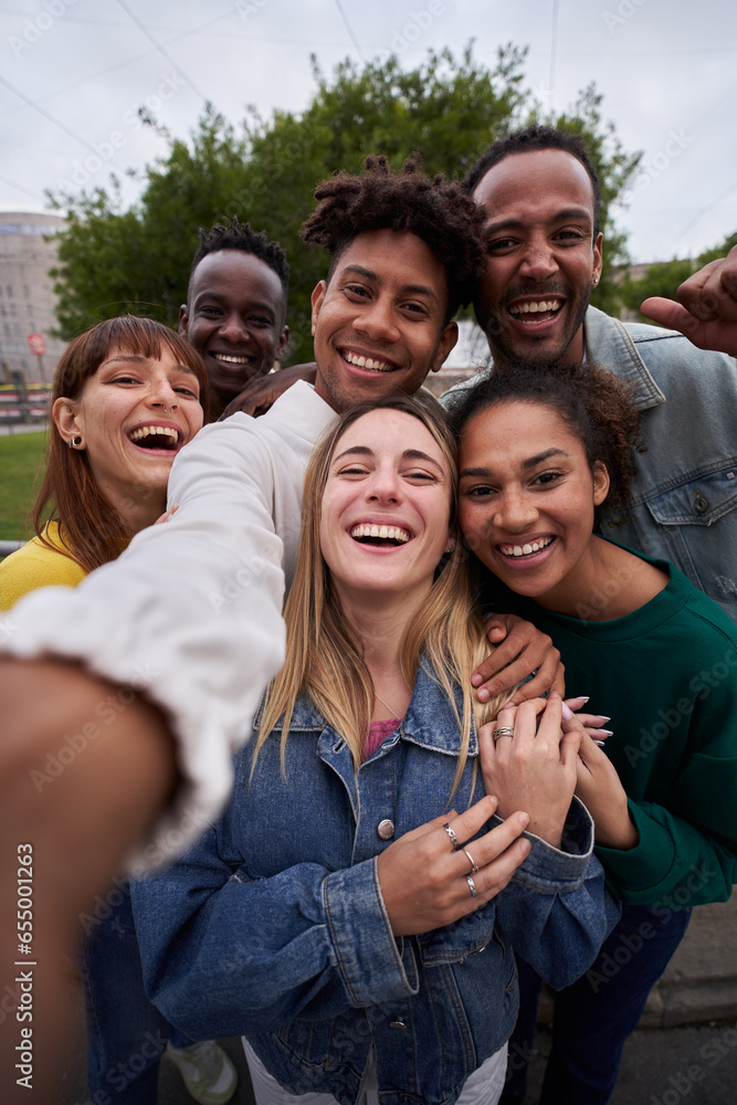 © CarlosBarquero - Vertical photo of Cheerful group of friends taking smiling selfie. Group of young people having fun together outdoors at park in the city enjoying travel in vacation holidays. High quality photo © CarlosBarquero - Vertical photo of Cheerful group of friends taking smiling selfie. Group of young people having fun together outdoors at park in the city enjoying travel in vacation holidays. High quality photo