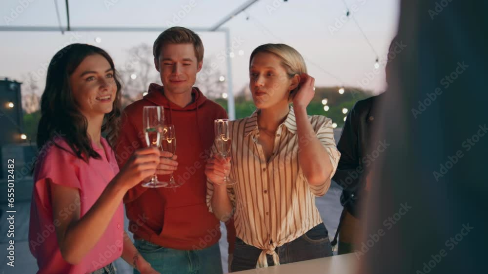 Diverse youngsters toasting drinks in sunset bar terrace. Friends celebrating Diverse youngsters toasting drinks in sunset bar terrace. Friends celebrating