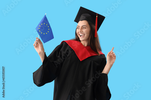 Happy female graduate holdi...