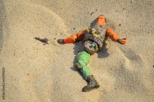 Broken toy in the sand photo