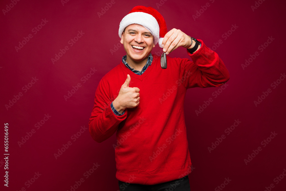 Fototapeta premium Attractive cheerful man buying a car on christmas