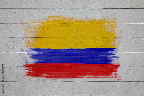 Columbian national flag colors painted on brick wall photo