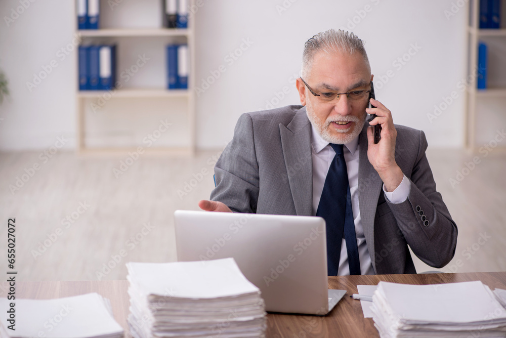 Old male employee and too much work at workplace Old male employee and too much work at workplace
