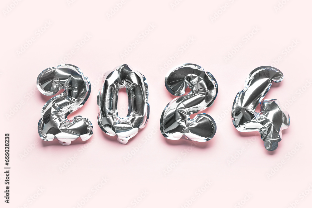 Silver foil balloons number 2024 on pink background. New year concept. Silver foil balloons number 2024 on pink background. New year concept.
