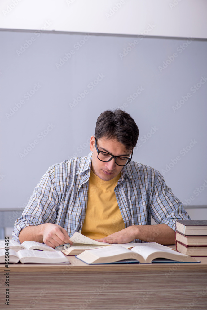 Young male student preparing for exams in the classroom Young male student preparing for exams in the classroom
