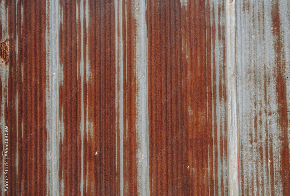 An old rusty metal sheet roof textured. Rust is an iron oxide formed by the reaction of iron and oxygen in the catalytic presence of water or air moisture. - obrazy, fototapety, plakaty 