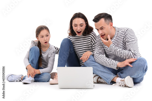 Happy family with laptop is...